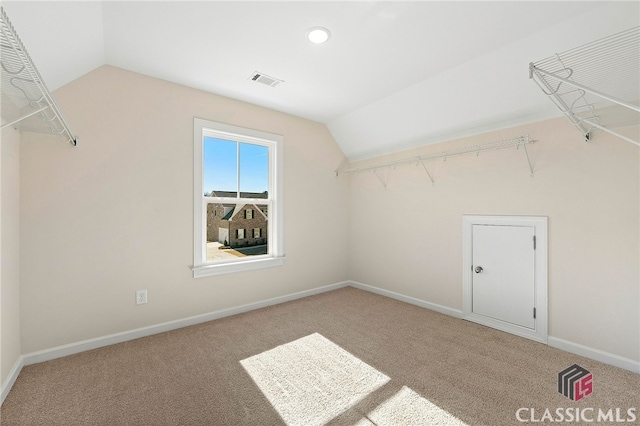 walk in closet with lofted ceiling and carpet floors