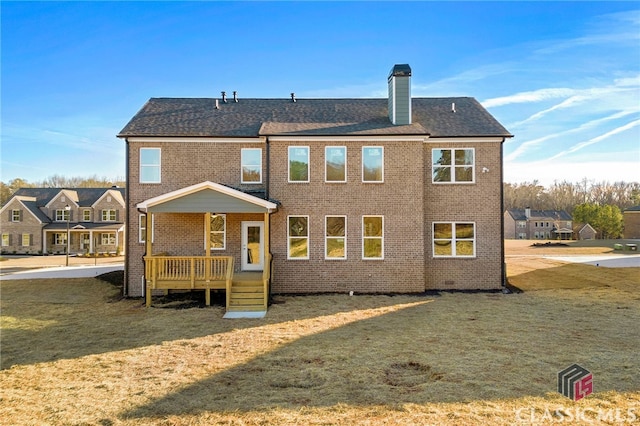 rear view of house with a lawn