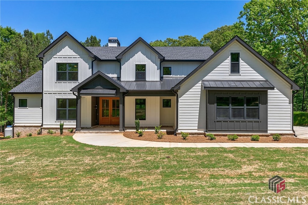 modern farmhouse style home featuring a front lawn and covered porch