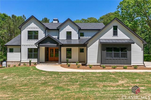 modern farmhouse style home featuring a front lawn and covered porch