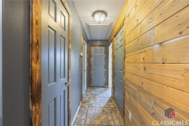 hall with tile flooring and a textured ceiling