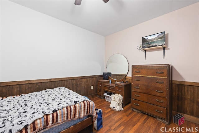 bedroom with ceiling fan and dark hardwood / wood-style flooring