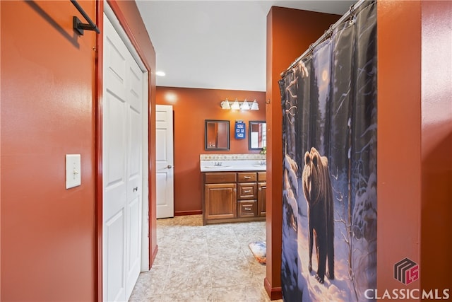 bathroom featuring tile flooring and vanity