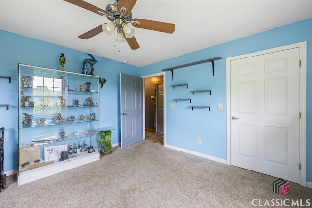 unfurnished bedroom featuring ceiling fan and carpet floors