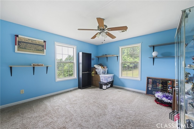 sitting room featuring carpet and ceiling fan