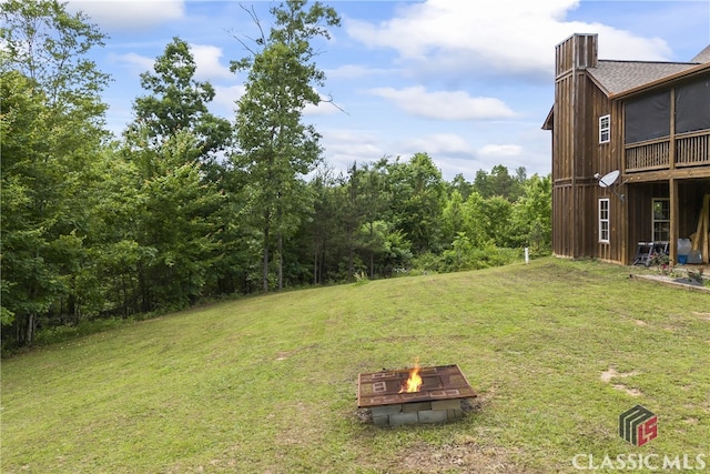 view of yard with an outdoor fire pit