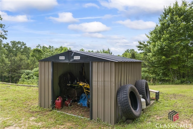 view of outdoor structure featuring a lawn