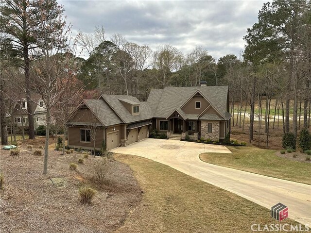 view of front of property with a front yard and a garage