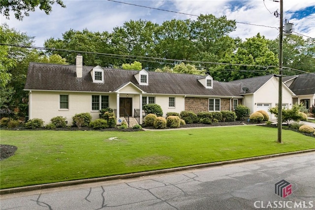 new england style home with a front lawn