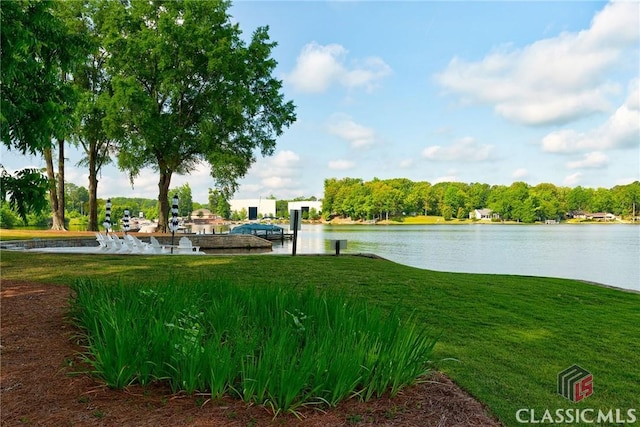 surrounding community featuring a lawn and a water view