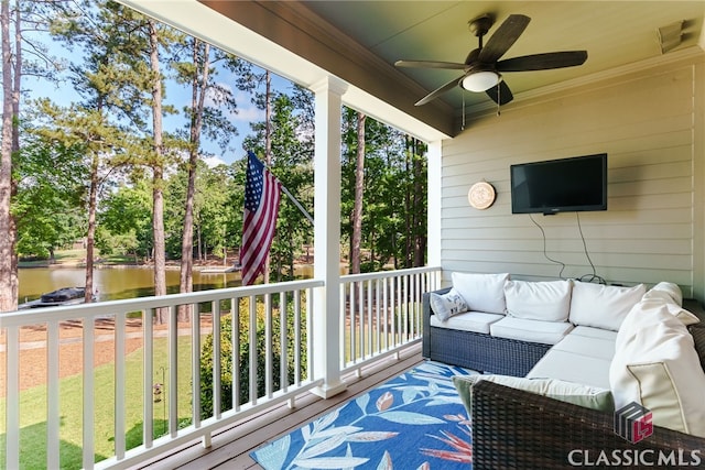 sunroom with a water view and ceiling fan