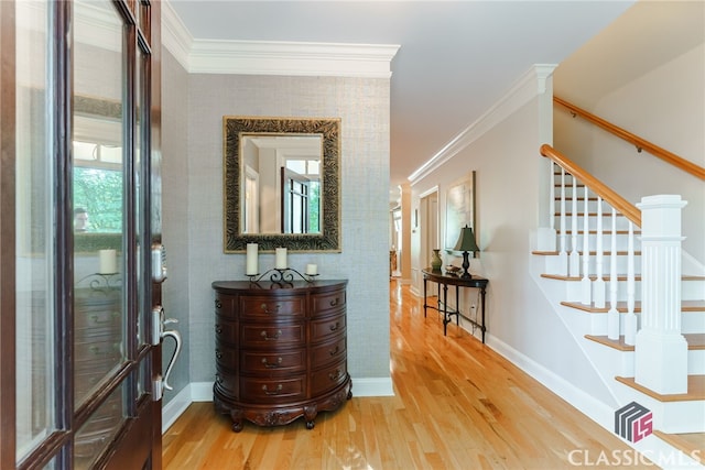 hall with hardwood / wood-style floors and ornamental molding