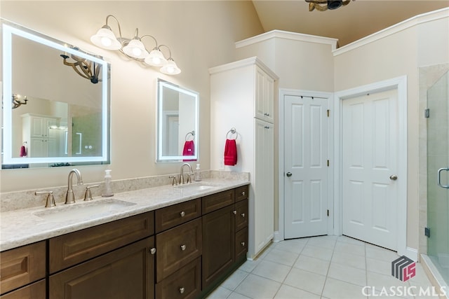 bathroom featuring tile patterned floors, a shower with door, and vanity