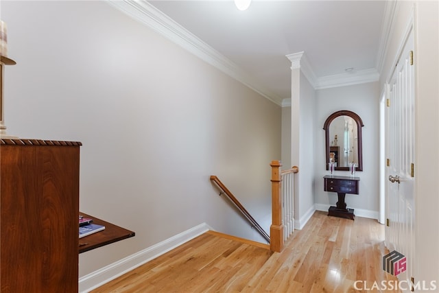 corridor featuring light wood-type flooring and ornamental molding