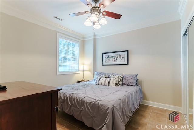 tiled bedroom featuring ceiling fan and ornamental molding