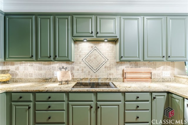 kitchen with black electric cooktop, light stone counters, and green cabinetry