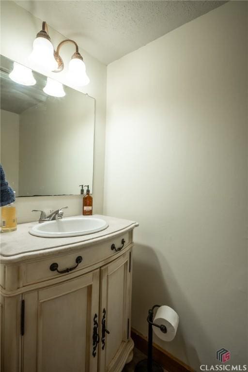 bathroom featuring vanity and a textured ceiling