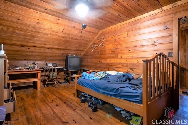 bedroom with wooden ceiling, wooden walls, wood-type flooring, and vaulted ceiling