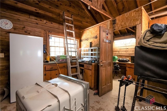 kitchen with wooden walls, lofted ceiling, and white refrigerator