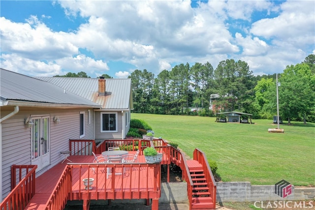 wooden terrace featuring a yard