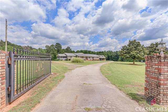 view of gate featuring a yard