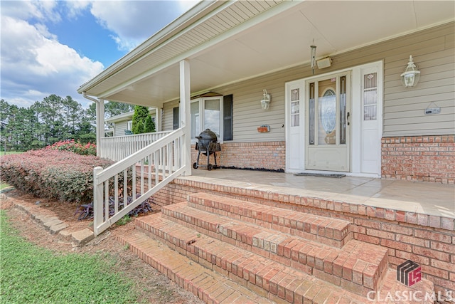 view of exterior entry featuring a porch