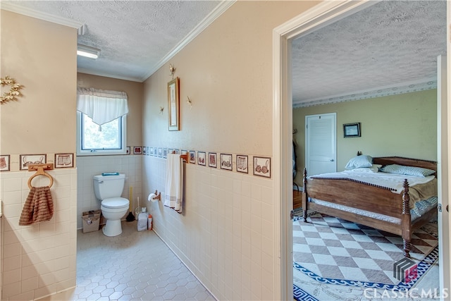 bathroom featuring tile flooring, crown molding, tile walls, a textured ceiling, and toilet