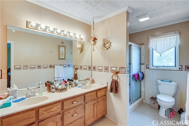 bathroom featuring tile flooring, tile walls, a textured ceiling, and double vanity