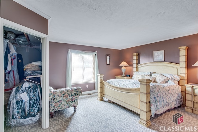 bedroom featuring a textured ceiling and a closet