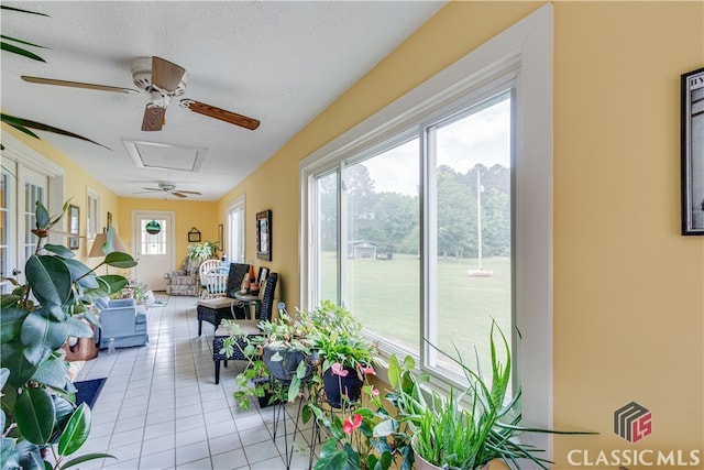 sunroom with a healthy amount of sunlight and ceiling fan