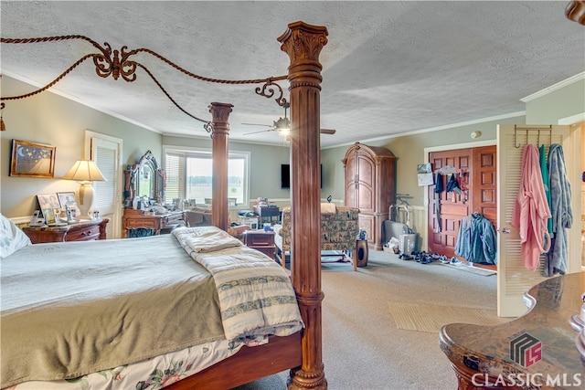 carpeted bedroom with crown molding and a textured ceiling