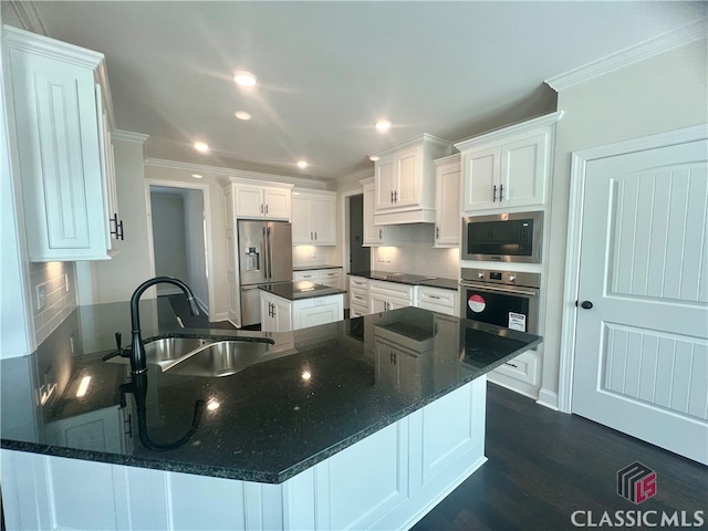 kitchen with dark hardwood / wood-style floors, stainless steel appliances, tasteful backsplash, white cabinetry, and sink