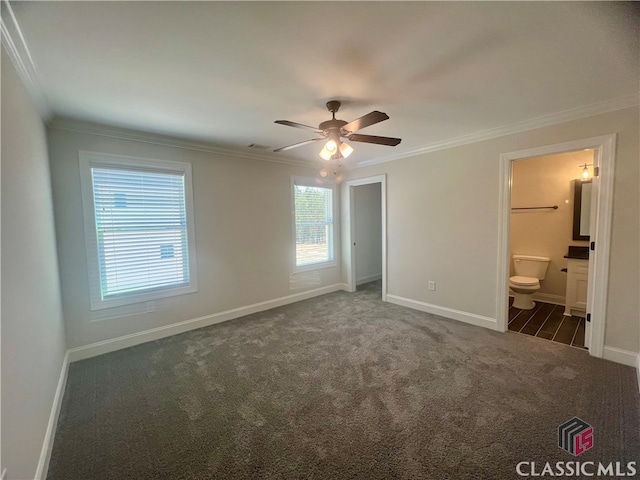 unfurnished bedroom featuring ceiling fan, dark colored carpet, and ornamental molding