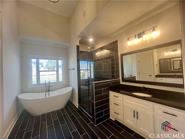 bathroom featuring a bath to relax in, vanity, and ornamental molding