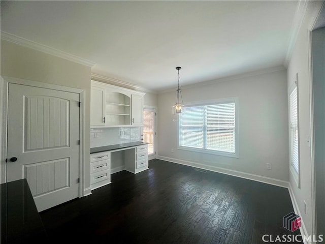 interior space featuring dark hardwood / wood-style floors, ornamental molding, backsplash, and white cabinetry