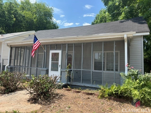 view of front of home featuring a sunroom