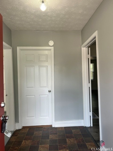 hall with a textured ceiling