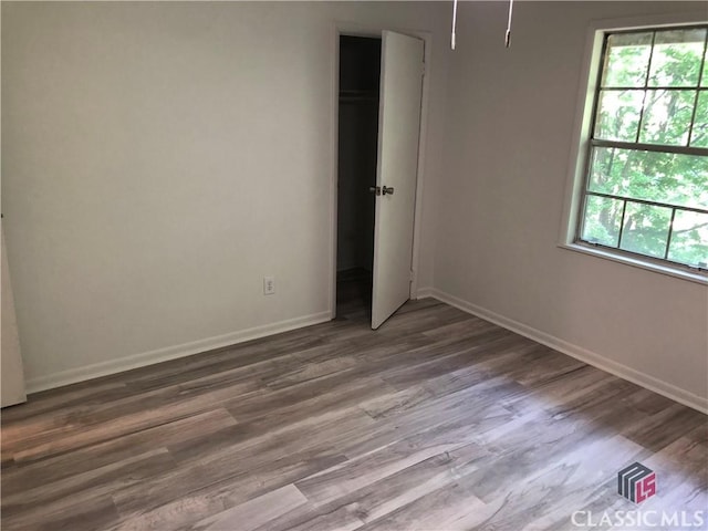 unfurnished bedroom with hardwood / wood-style flooring