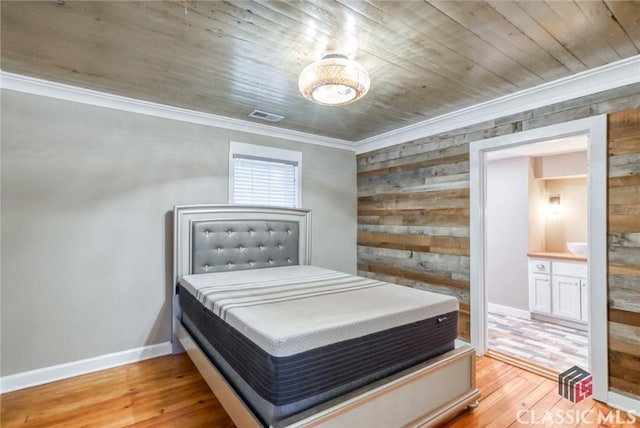 bedroom with ornamental molding, wooden ceiling, light hardwood / wood-style flooring, and wood walls