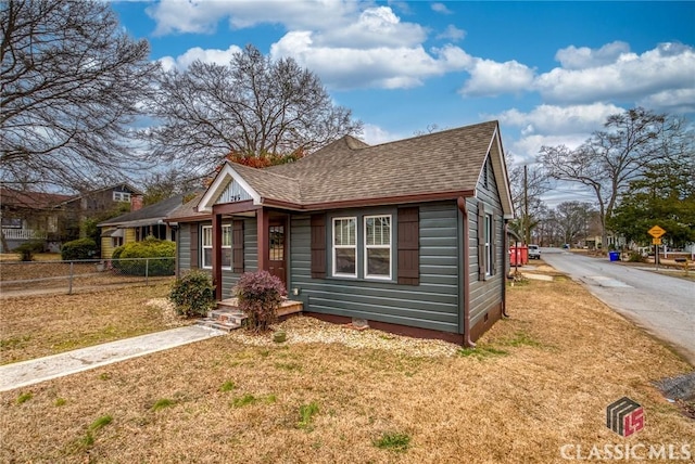 bungalow-style home with a front yard