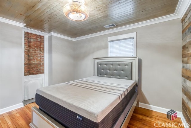 bedroom featuring crown molding, wooden ceiling, and hardwood / wood-style flooring