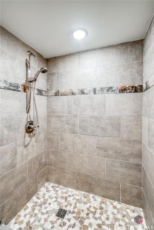 bathroom with tiled shower