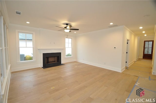 unfurnished living room with light hardwood / wood-style flooring, ceiling fan, and crown molding