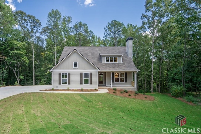 view of front of house with covered porch and a front yard