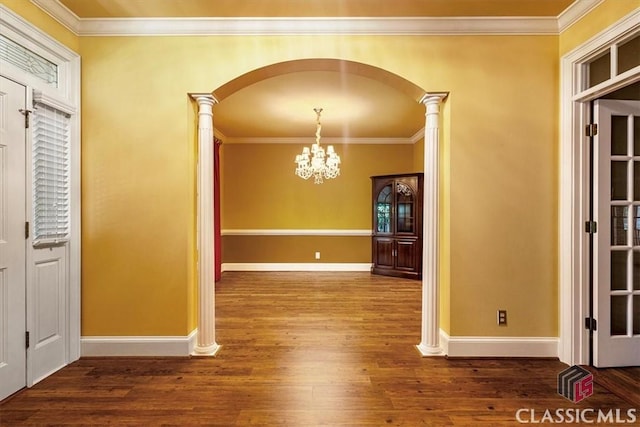 unfurnished dining area featuring decorative columns, dark hardwood / wood-style flooring, and ornamental molding