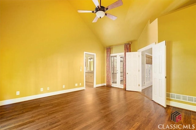 unfurnished bedroom featuring high vaulted ceiling, hardwood / wood-style flooring, ensuite bath, and ceiling fan