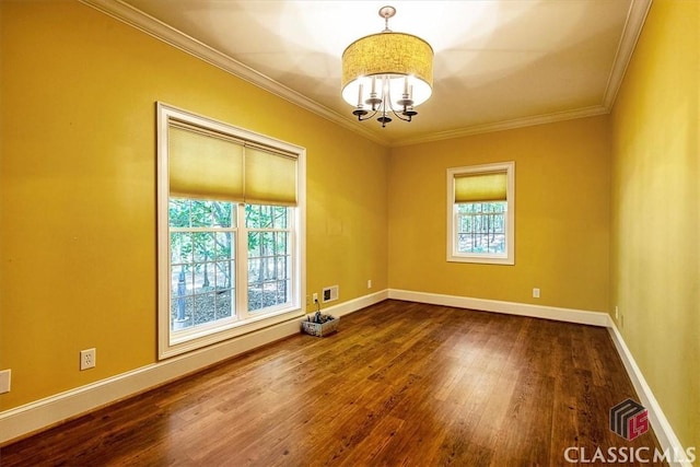 empty room featuring an inviting chandelier, crown molding, and wood-type flooring