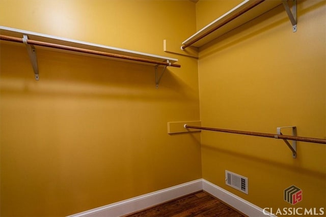 spacious closet featuring dark hardwood / wood-style floors