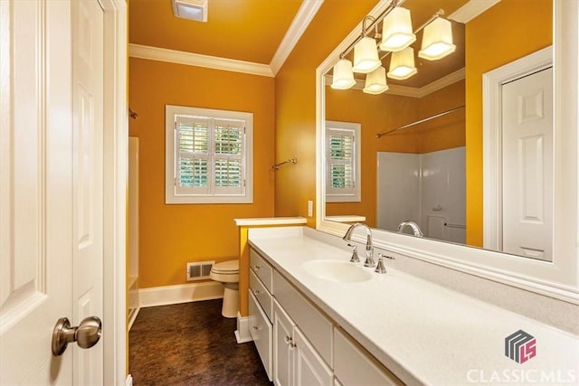 bathroom featuring toilet, vanity, and crown molding