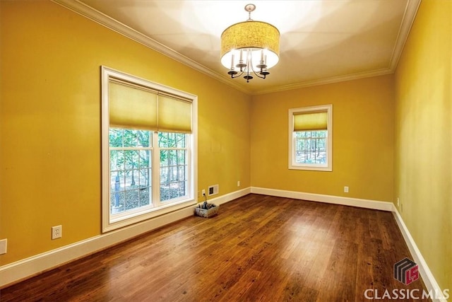 spare room featuring a chandelier, crown molding, and hardwood / wood-style flooring